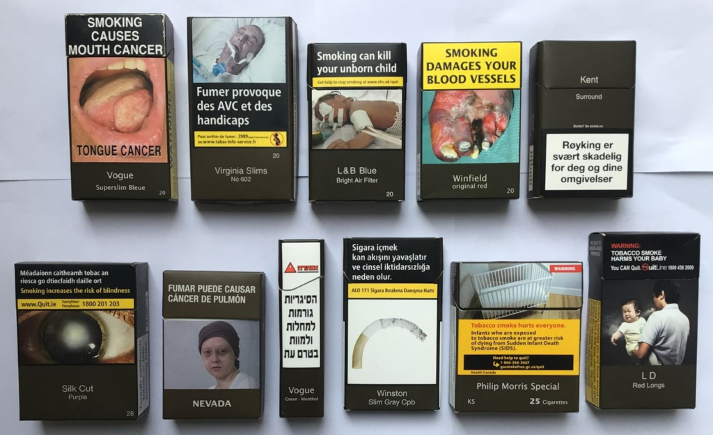 Examples of cigarette packs with different health warning labels and placement styles for regulatory comparison